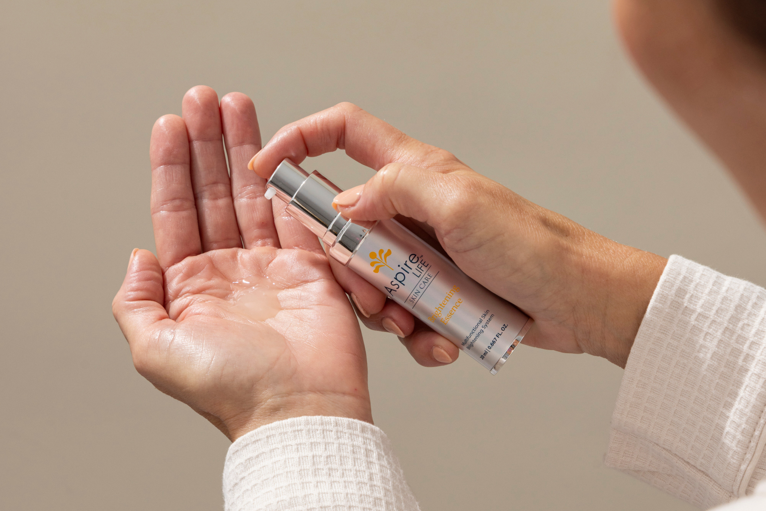 AspireLIFE® Brightening Essence – skin brightening moisturizer with Vitamin C, licorice root, and marine actives to reduce discoloration.